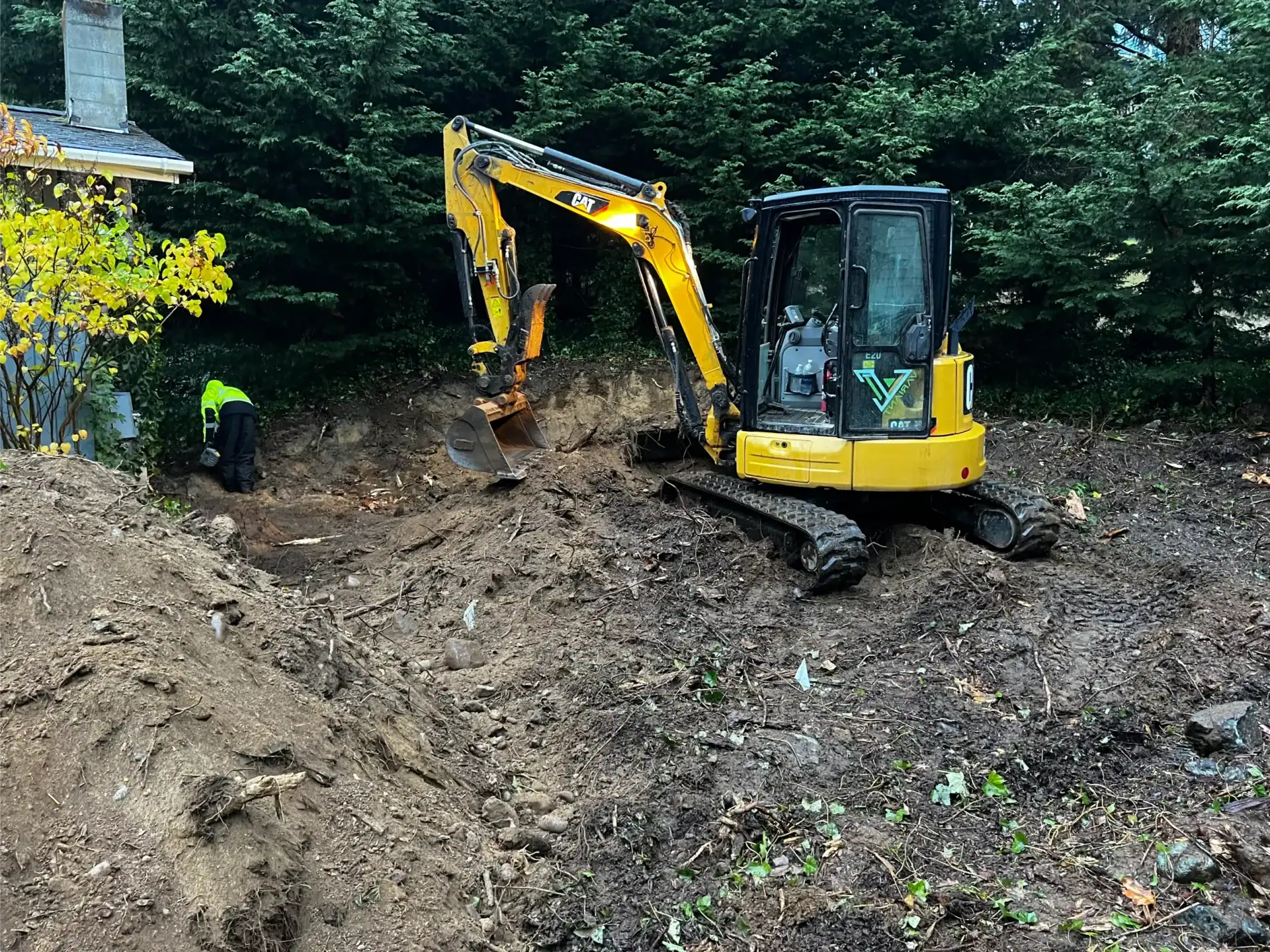Why Hiring the Right Excavation Contractor Matters 1 yellow excavator digging trench near the house